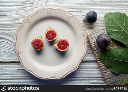 figs raw cutted fig fruits on white plate and wooden table