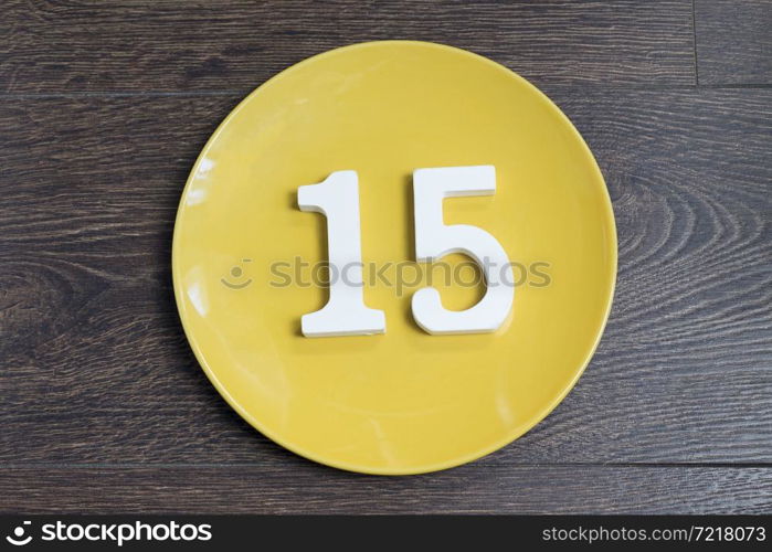Figure fifteen on the yellow plate and brown background.. Figure fifteen on the yellow plate.