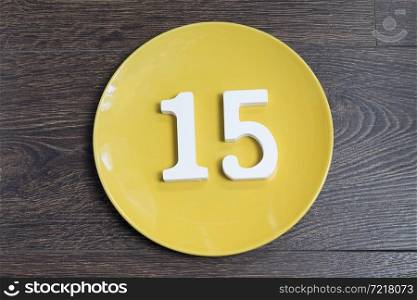 Figure fifteen on the yellow plate and brown background.. Figure fifteen on the yellow plate.