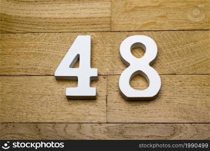 Figure forty-eight on a wooden, parquet floor as a background.. Figure forty-eight on the wooden, parquet floor.