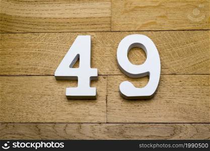 Figure forty-nine on a wooden, parquet floor as a background.. Figure forty-nine on the wooden, parquet floor.