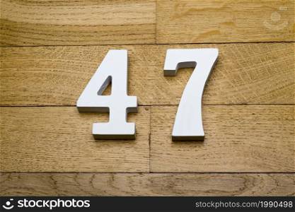 Figure forty-seven on a wooden, parquet floor as a background.. Figure forty-seven on the wooden, parquet floor.