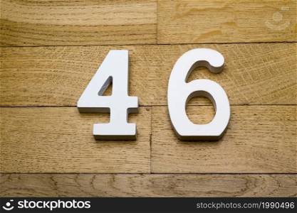 Figure forty-six on a wooden, parquet floor as a background.. Figure forty-six on the wooden, parquet floor.