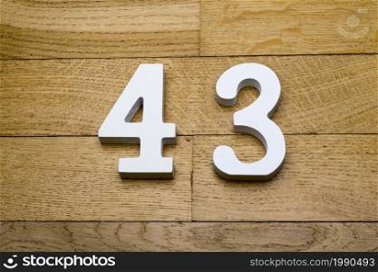Figure forty-three on a wooden, parquet floor as a background.. Figure forty-three on a wooden, parquet floor.
