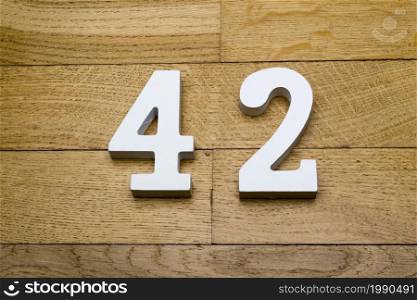 Figure forty-two on a wooden, parquet floor as a background.. Figure forty-two on the wooden, parquet floor.