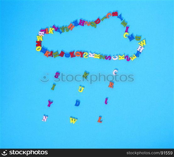 figure of a cloud of multi-colored wooden letters on a blue background