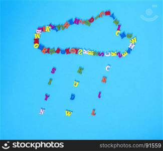 figure of a cloud of multi-colored wooden letters on a blue background