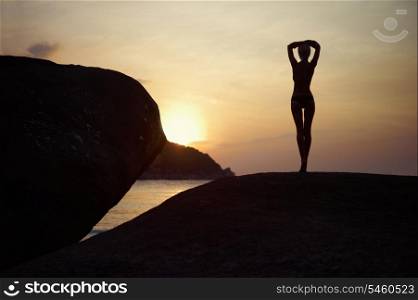 Figure of a girl in contre at sunset on the sea