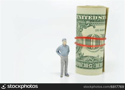 Figure of businessman and one dollar bill. Wealth concept