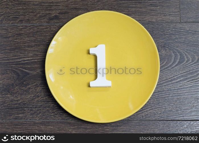 Figure one on the yellow plate and brown background.. Figure one on the yellow plate.