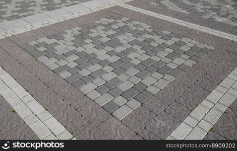 Figure out the paving slabs in the square. Background of paving slabs. Texture of stone products.. Figure out the paving slabs in the square. Background of paving slabs. Texture of stone products