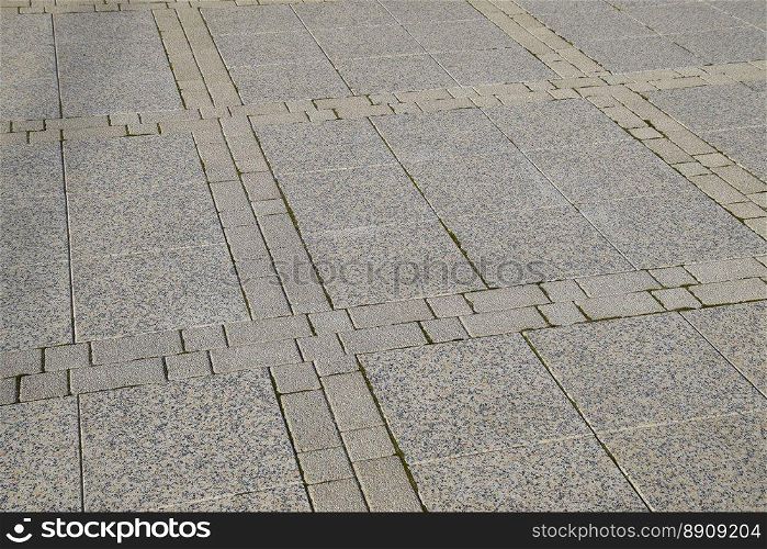 Figure out the paving slabs in the square. Background of paving slabs. Texture of stone products.. Figure out the paving slabs in the square. Background of paving slabs. Texture of stone products
