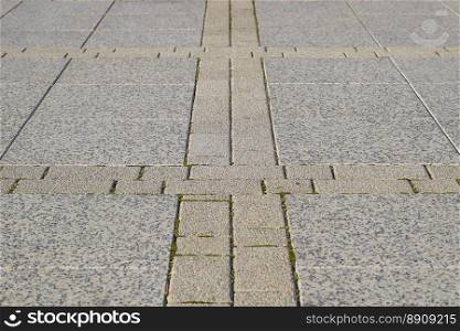 Figure out the paving slabs in the square. Background of paving slabs. Texture of stone products.. Figure out the paving slabs in the square. Background of paving slabs. Texture of stone products