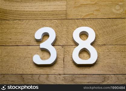 Figure thirty-eight on a wooden, parquet floor as a background.. Figure thirty-eight on a wooden, parquet floor.