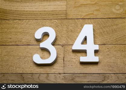 Figure thirty-four on a wooden, parquet floor as a background.. Figure thirty-four on a wooden, parquet floor.