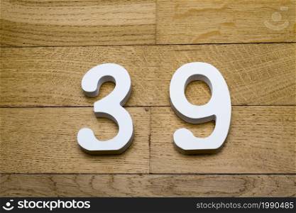 Figure thirty-nine on a wooden, parquet floor as a background.. Figure thirty-nine on the wooden, parquet floor.