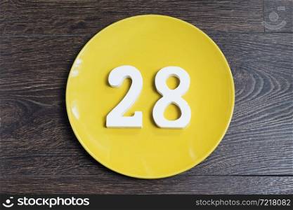 Figure twenty-eight at the plate yellow and brown background.. Figure twenty-eight on the yellow plate.