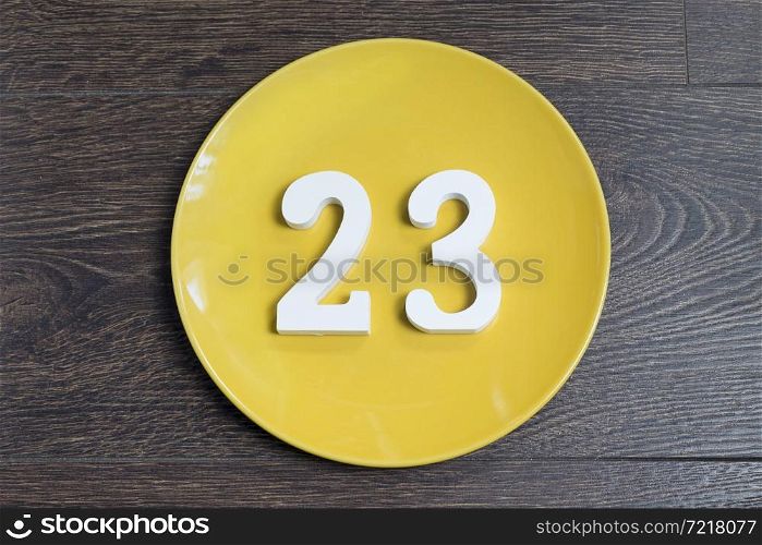 Figure twenty-three at the plate yellow and brown background.. Figure twenty-three one-on-yellow plate.