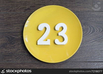 Figure twenty-three at the plate yellow and brown background.. Figure twenty-three one-on-yellow plate.