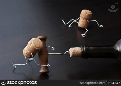 Figures from wine corks and bottle with the corkscrew