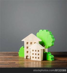 Figures of houses and trees. Affordable comfortable housing. Purchase of apartments and real estate, rent and sale. Housing, new home. Mortgage. Cozy ecological modern neighborhood. Urban science