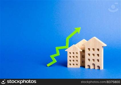 figures of residential buildings and green arrow up. Growth in demand and liquidity for real estate, increase in rates for the maintenance of buildings. Rising value and price. Apartments for sale