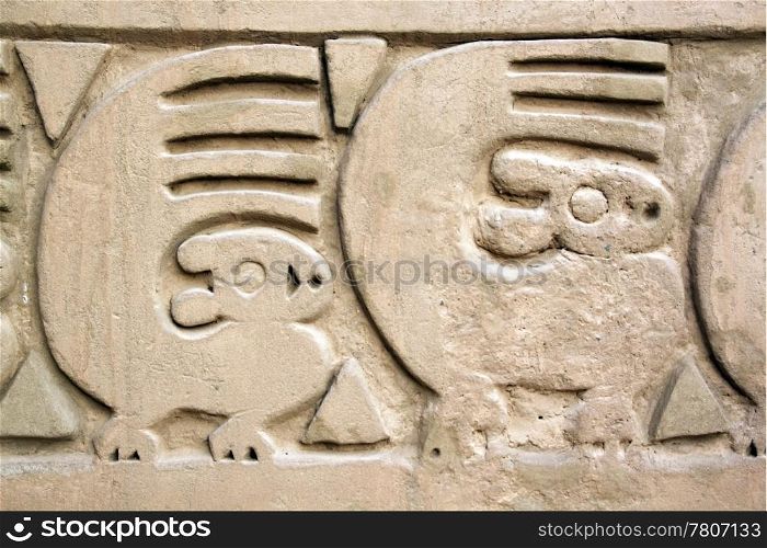 Figures on the wall of ruins in Chan Chan, north Peru