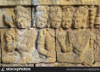 Figures on the yellow wall of Borobudur, Java, Indonesia