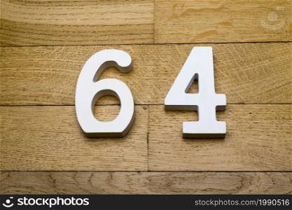 Figures sixty-four on a wooden, parquet floor as a background.. The figures are sixty-four wooden parquet floor.