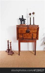 Figurine and lanterns on a chest with candlestick holders