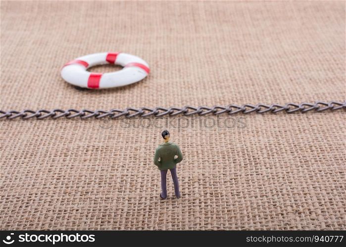 Figurine and life preserver with with a chain in the middle them