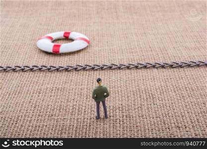 Figurine and life preserver with with a chain in the middle them