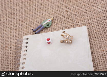 Figurine notebook and model crown