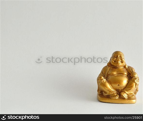 Figurine of a laughing and cheerful golden Buddha