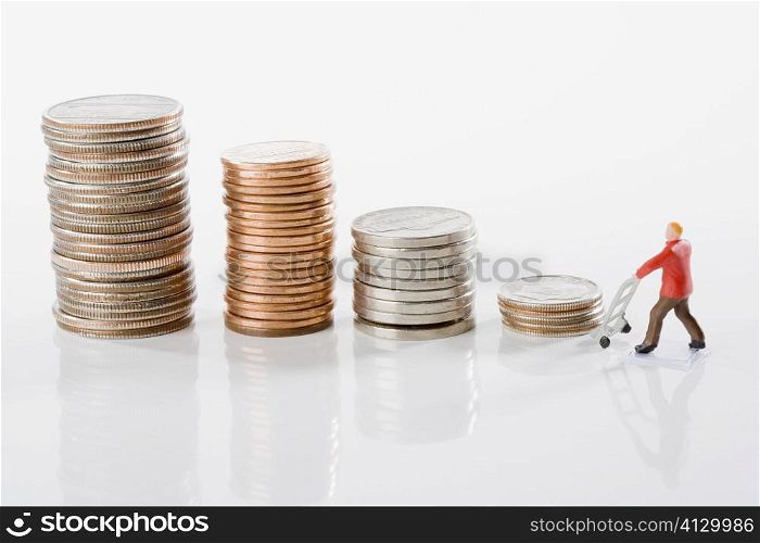 Figurine of a manual worker with stacks of coins