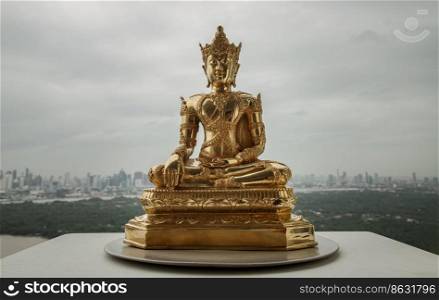 Figurine of Gold Brass Phra Phut Sik Khi Thotsaphon  First Buddha  buddha sculpture statue with nature background. Space for text, Selective focus.