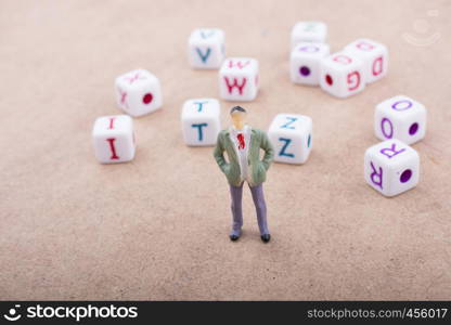 Figurine standing in front of the colorful alphabet letter cubes