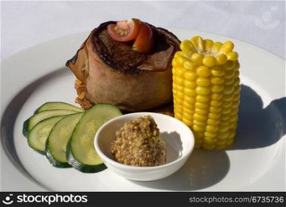 Filet Mignon, served on Potato Rosti, and accompanied by a Steamed Corn, Zucchini, and Seeded Mustard
