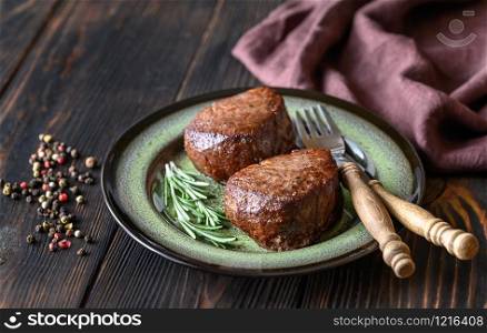 Filet mignon with fresh rosemary and peppercorn on the plate