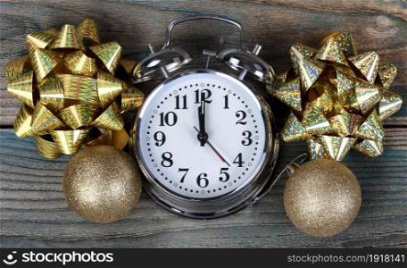 Filled frame of happy New Year gold decorations plus clock striking midnight
