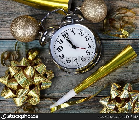 Filled frame of happy New Year gold party decorations plus clock striking midnight