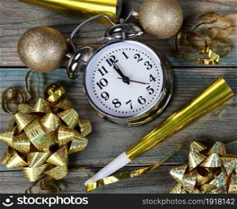 Filled frame of happy New Year gold party decorations plus clock striking midnight
