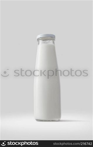 Filled glass bottle with fresh milk on a white background. Healthy food. Bottle of milk isolated on white background
