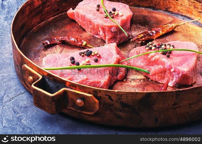fillet of beef in spices, vintage copper pan