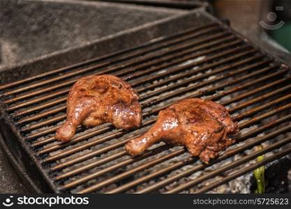fillet of duck legs on a grill preparing