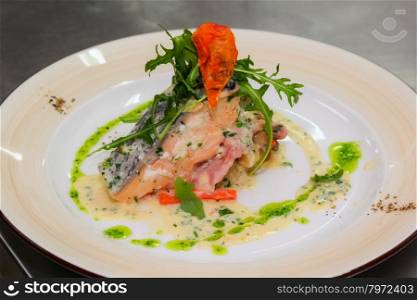 Fillet of Norwegian salmon with garlic, confit tomatoes and pesto