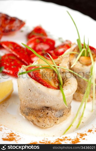 fillet of pikeperch stuffed with trout fish with baked pepper, tomato and leek