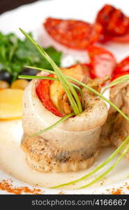 fillet of pikeperch stuffed with trout fish with baked pepper, tomato and leek