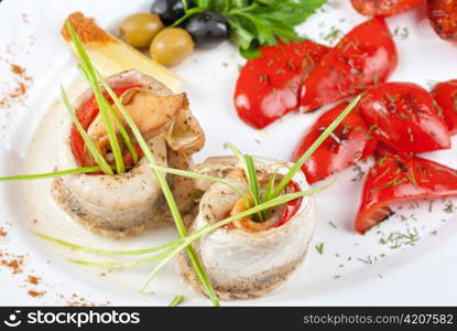 fillet of pikeperch stuffed with trout fish with baked pepper, tomato and leek