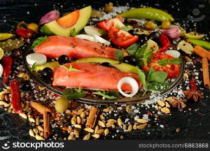 Fillet of salmon and spices on a dark background